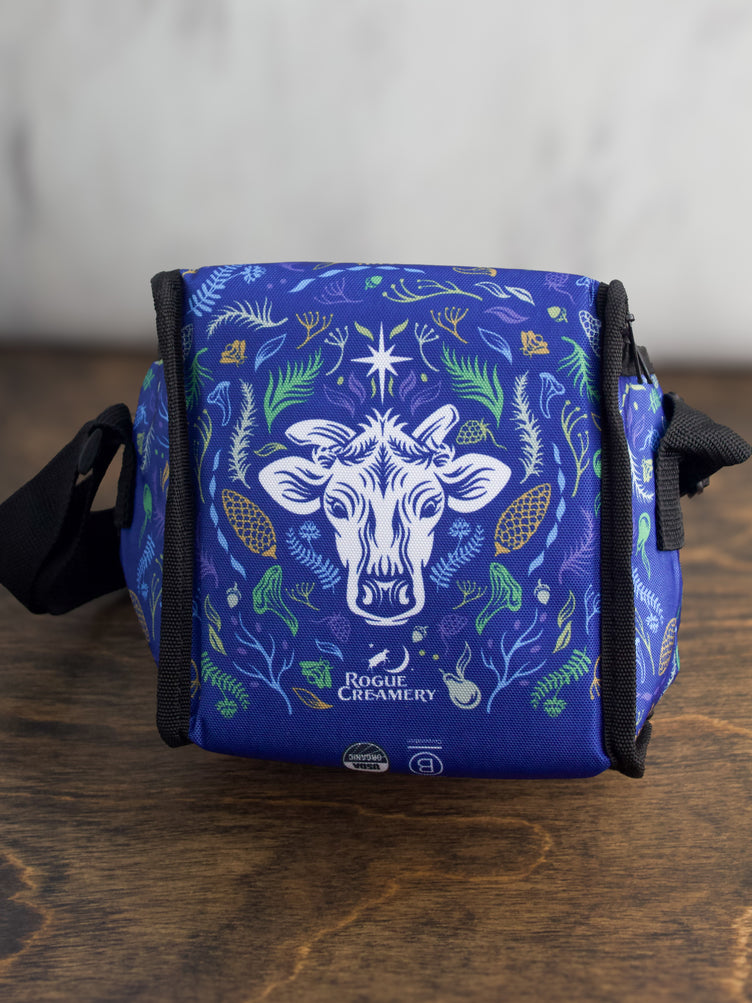 The bottom of the blue cooler bag, highlighting the sturdy black base and part of the floral design.