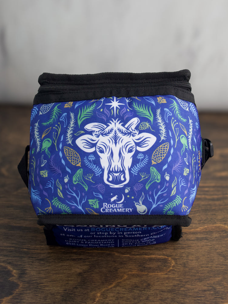 The top of a blue insulated cooler bag showing the Rogue Creamery logo and floral patterns.