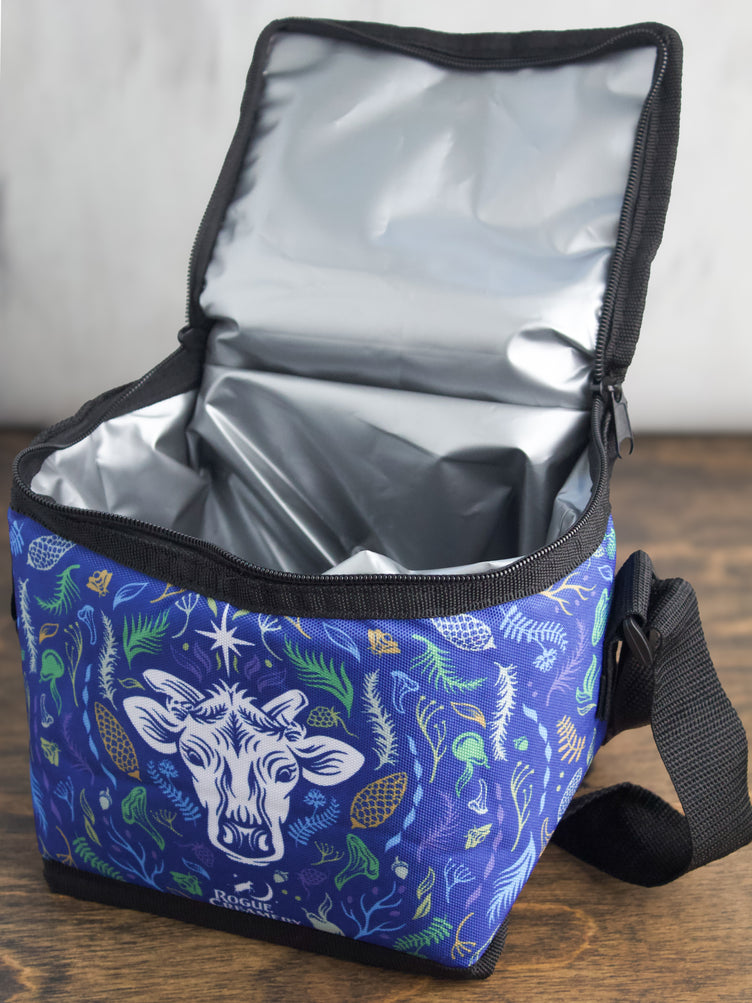 The Flora Cow cooler bag open, displaying its insulated interior ready to keep snacks and drinks cool.