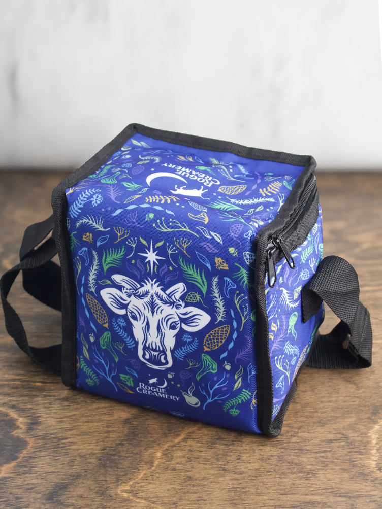 A side view of the blue cooler bag, featuring the floral pattern and black zipper closure.