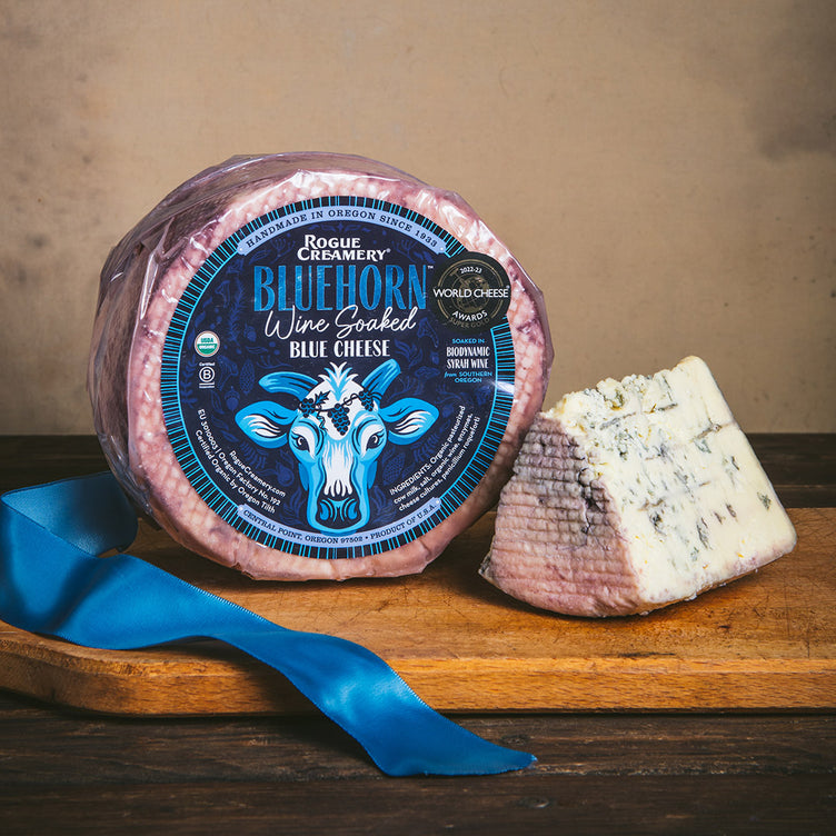 Rogue Creamery Bluehorn Whole Wheel on cutting board with ribbon